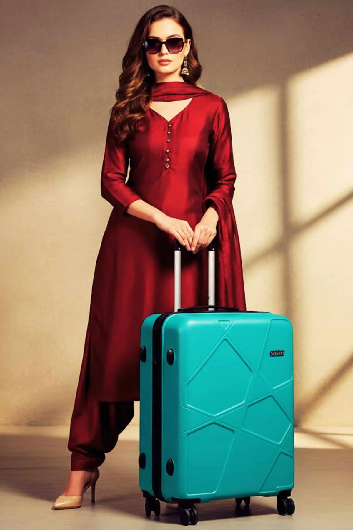 Woman posing with Safari Pentagon Pro green luggage set — best travel trolley bags