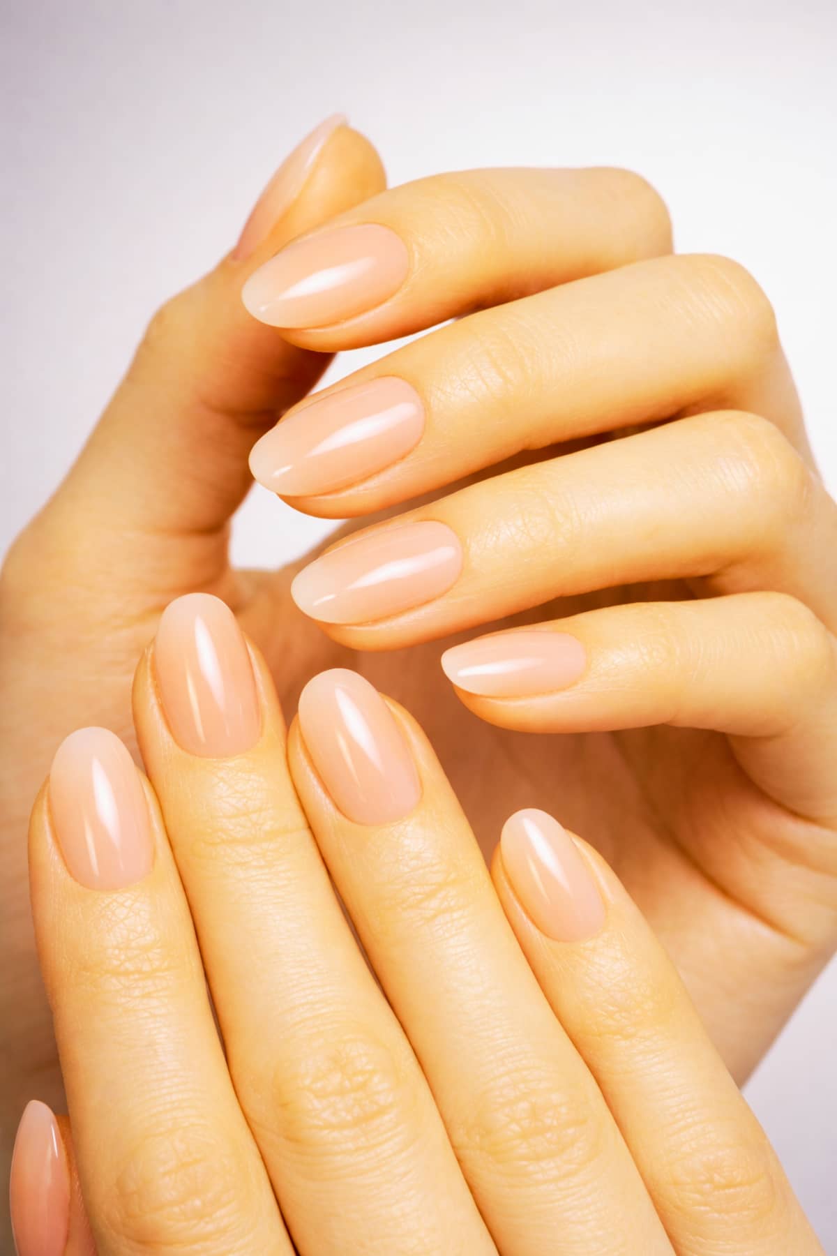 Milky jelly gel polish manicure with glossy translucent pink clear finish in luxury editorial style