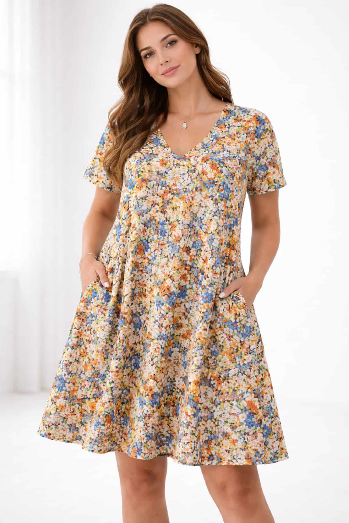 Multicolor floral plus size women’s dress with pockets — worn by a beautiful 23-year-old woman with very fair natural skin, bright blue eyes, brown silky hair, fit toned body, peaceful confident expression, casual swing sundress for everyday comfort