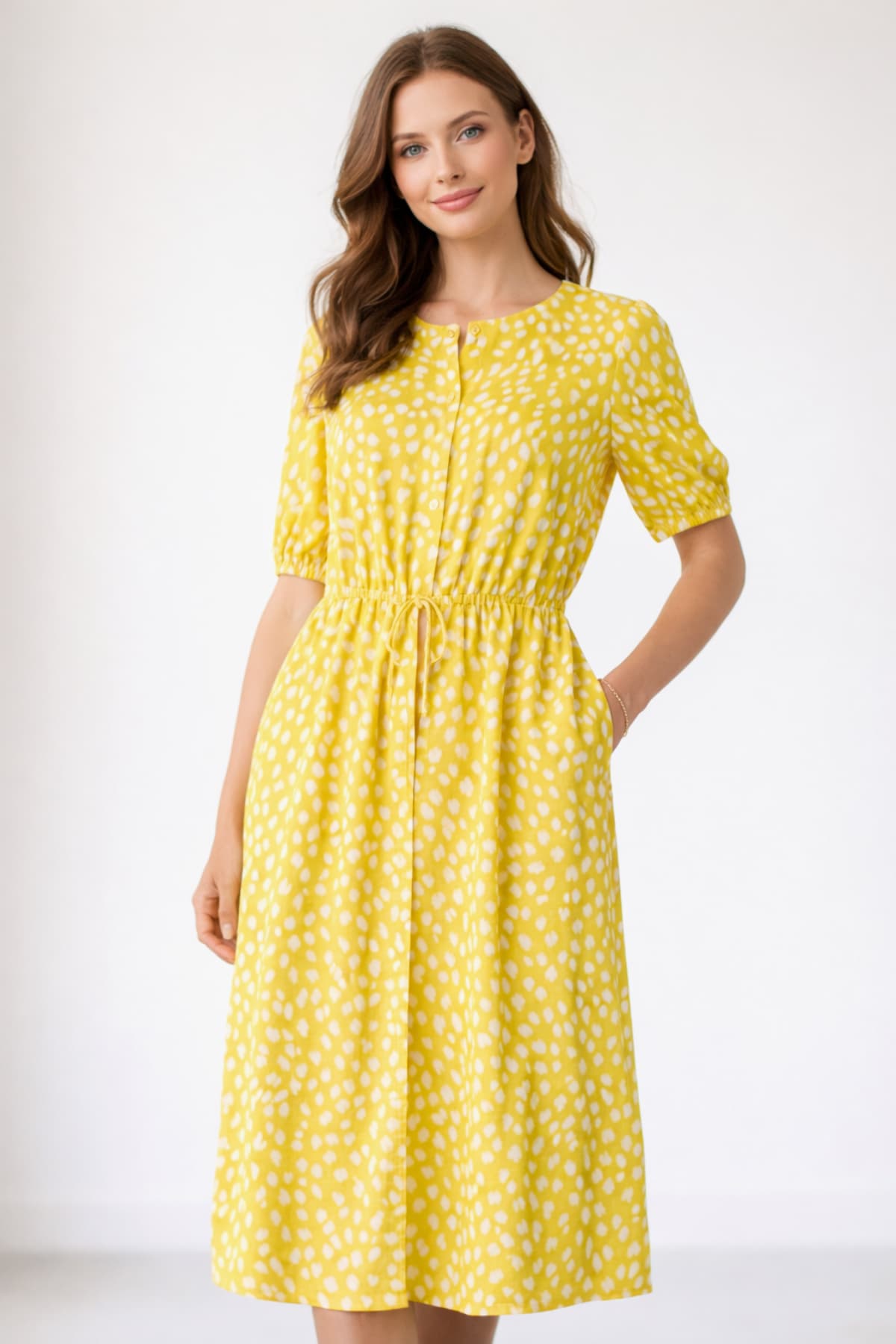 Yellow women’s midi dress with drawstring waist and pockets — worn by a beautiful 23-year-old woman with very fair natural skin, bright blue eyes, brown silky hair, fit toned body, peaceful confident expression, lightweight casual midi dress