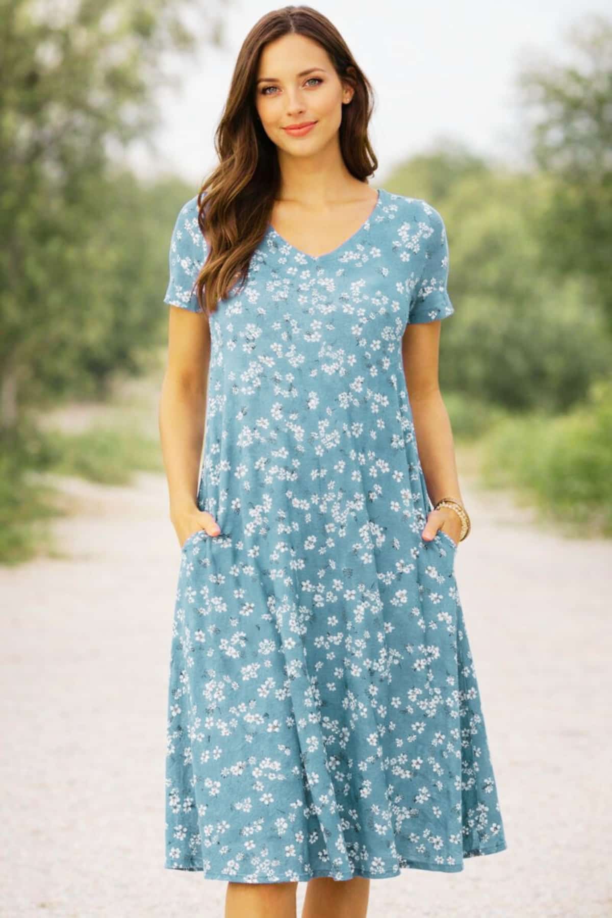 soft lightweight fabric with a relaxed fit for easy daily wear, worn by a beautiful 23-year-old woman with very fair natural skin, bright blue eyes, brown silky hair, fit toned physique, peaceful confident expression in a clean summer outdoor setting